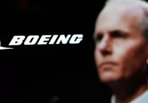 Logo of the Boeing Company^ with CEO Dave Calhoun in the background