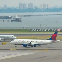 : Delta Airlines and American Eagle planes seen at the runway of LaGuardia International Airport. Manhattan^ New York^ USA - August 5^ 2025