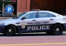 Prince George's County^ Maryland police car sits parked on a street in National Harbor in front of a public parking garage.
