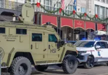City police^ state police and Homeland Security officers^ and an armored vehicle and state patrol vehicle on Canal Street near the entrance to Bourbon Street New Orleans^ LA^ USA - January 2^ 2025