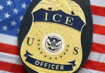 US ICE Officer badge on United States of America flag close up