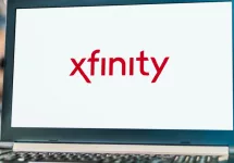 Laptop computer displaying logo of Xfinity^ the trade name of Comcast Cable Communications^ LLC to market consumer cable television^ internet^ telephone.