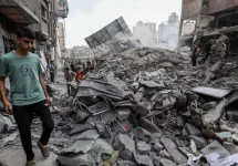 People search the Khan Yunis municipality building after an Israeli air strike^ in the city of Khan Yunis^ southern of the Gaza Strip^ October 10^ 2023.