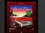 An Apple iPad displays the Spotify music streaming application^ which is playing the song "Choosin' Texas" by the artist Ella Langley
