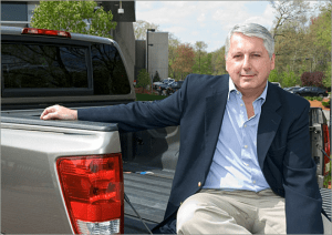 Car Doctor, John Paul sitting on back of truck