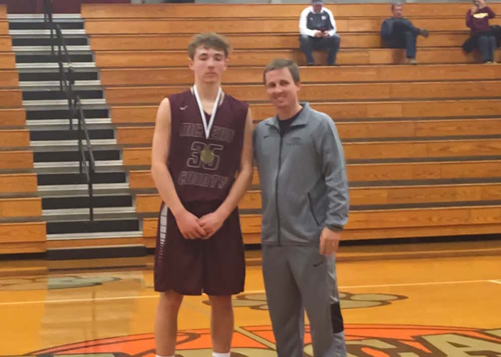 McLean County sophomore Logan Patterson had 14 points and four rebounds against St. Mary in the first round.  He is pictured with Trigg County basketball coach Payton Croft. 