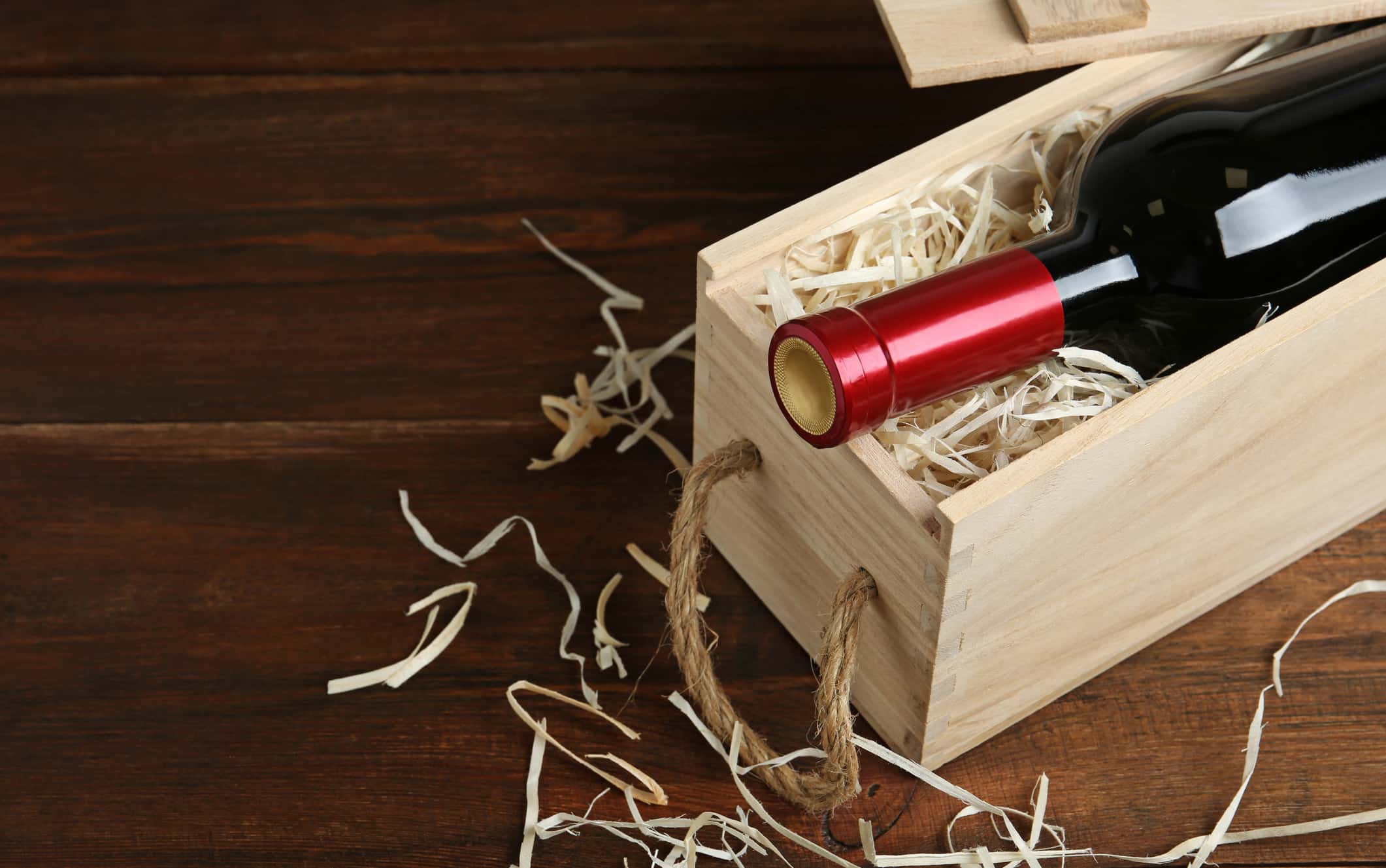 open-wooden-crate-with-bottle-of-wine-on-table-space-for-text