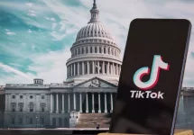 TikTok sign in the foreground^ while American Congress building is blurred in the background^ concept for TikTok ban in the United States