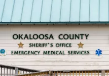 Okaloosa Island county Sheriff's Office emergency medical services building with sign by beach by ramp in Florida Panhandle^ Gulf of Mexico