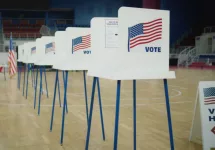 Voting booths with American flag logo at polling station. National Election Day in the United States of America.