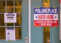 Signs on polling place door during voting on presidential election day in northern Virginia. ARLINGTON^ VIRGINIA^ USA - NOVEMBER 3^ 2020