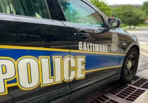 BALTIMORE^ MARYLAND - JULY 29^ 2023: Baltimore Maryland police department sign on police cruiser