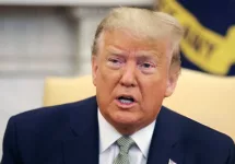 President Donald Trump talks to journalists at the Oval Office at the White House March 12^ 2020 in Washington^ DC.