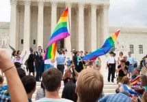 Crowd waving flags in support of LGBTQ community gathers at the U.S. Supreme Court ; WASHINGTON June 26^ 2015