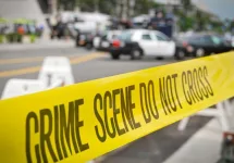 crime or accident scene sign do not pass the line with police cars in the background
