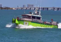 Miami-Dade fire-rescue boat patrolling on Biscayne Bay with Julia Tuttle causeway bridge in the distant background. Miami Beach^Florida^U.S.A. 13 March2021