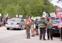 Florida Everglades June 28^ 2025 Protesters line the highway in the Florida Everglades to oppose the construction of "Alligator Alcatraz"^ a new immigrant detention center.