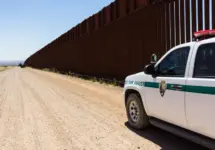 Police car stopped near the border fence of the USA . Arizona^ USA - June 28^ 2016