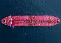 Aerial view crude oil tanker ship at sea^ Red crude oil tanker ship top view^ Logistic and maritime transpoprtation of petroleum^ Modern offshore terminal loading tanker ship.