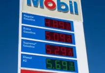 Mobil gas station sign showing high price of California Gasoline with bright blue sky Lone Pine^ CA^ USA - February 9th^ 2023