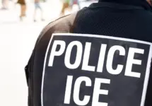 Ice police agent - Officer of Immigration and Customs Enforcement. Close up of POLICE ICE on back of stab proof vest worn by DHS Department of Homeland Security police officer at the scene of incident