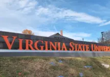Virginia State University sign on a hill overlooking painted Greek life rocks located in the village of Ettrick in Chesterfield County^ VA. Ettrick^ Virginia USA - November 24^ 2023
