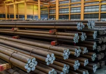 Rows of Steel Round Bar storage and stacking in the warehouse for industrial construction.