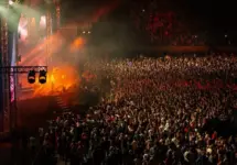 Large Concert Crowd and Stage Lighting in a Stadium at Night