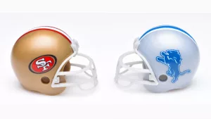 Football helmets of the San Francisco 49ers and Detroit Lions