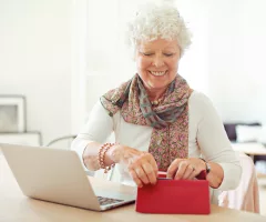 cheerful-old-woman-getting-something-from-her-wallet