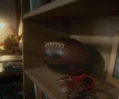 no-people-shot-of-brown-leather-rugby-ball-lying-next-to-various-retro-sunglasses-and-sbi-351336303