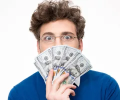 handsome-man-with-money-over-gray-background