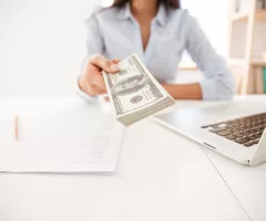 cropped-image-of-businesswoman-give-money-to-camera