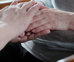 hands-of-a-young-grandson-are-held-by-grandmothers-wrinkled-hands-care-for-the-elderly-sbi-350552446