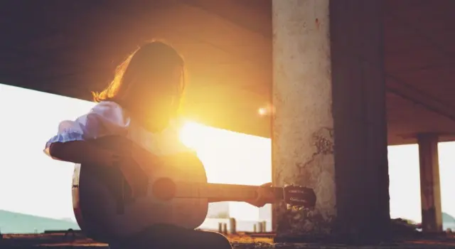 Candid silhouette woman chill play acoustic guitar musician Artists female sad mood activity music at balcony flare lighting sunset background
