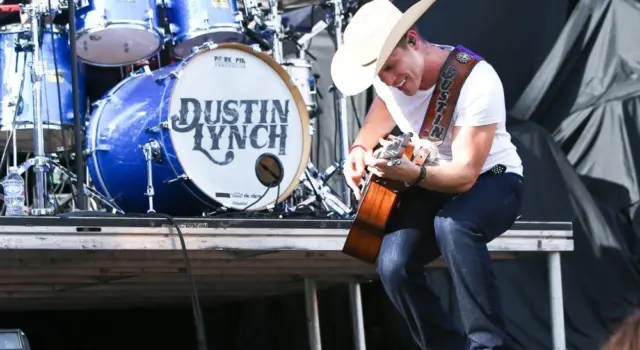 Dustin Lynch performs during the 'Kick The Dust Up' Tour at Vanderbilt Stadium on July 11^ 2015 in Nashville^ Tennessee.