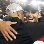 San Francisco 49ers quarterback Jimmy Garoppolo, right, celebrates with assistant coach Miles Austin after the NFL NFC Championship football game against the Green Bay Packers Sunday, Jan. 19, 2020, in Santa Clara, Calif. The 49ers won 37-20 to advance to Super Bowl 54 against the Kansas City Chiefs. (AP Photo/Tony Avelar)