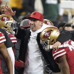 San Francisco 49ers head coach Kyle Shanahan, center, celebrates with players during the second half of the NFL NFC Championship football game against the Green Bay Packers Sunday, Jan. 19, 2020, in Santa Clara, Calif. The 49ers won 37-20 to advance to Super Bowl 54 against the Kansas City Chiefs. (AP Photo/Tony Avelar)