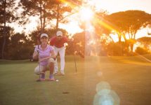 storyblocks-portrait-of-happy-young-couple-on-golf-course-with-beautiful-sunset-in-background_sdbpw8nzhw-jpg