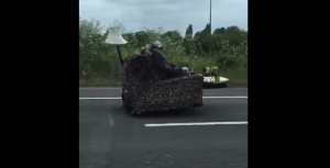 man-and-woman-driving-couch-on-road-png