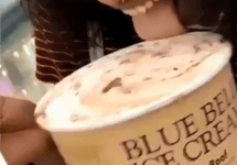 woman licks blue bell ice cream in store