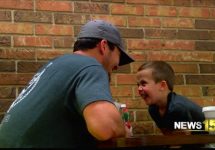 broussard boy gives out hi fives at ton's restaurant