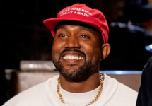 kanye-west-smiles-with-red-maga-hat-png-2