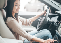woman-driving-car-radio-smiling