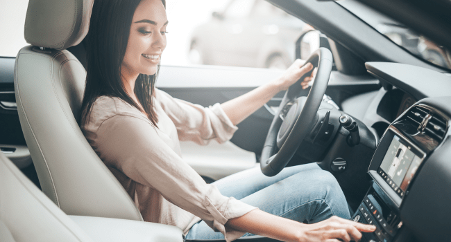 woman-driving-car-radio-smiling