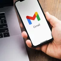 malehandholdingasmartphonewithgmailapponthe