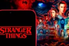 Computer keyboard with the Iphone 11 pro with the Stranger Things logo.