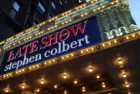 Manhattan NYC buildings in Times Square^ Broadway street avenue road^ signs for Stephen Colbert Late Show- Marquee / Theatre at Night