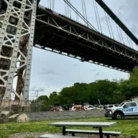 NYPD Police truck responding to a person who has climbed up the George Washington Bridge in Fort Washington Park New York^ NY USA - May 18^ 2024