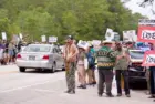 Florida Everglades June 28^ 2025 Protesters line the highway in the Florida Everglades to oppose the construction of "Alligator Alcatraz"^ a new immigrant detention center.